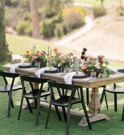 outdoor luxury wedding table set up with colorful fall flowers
