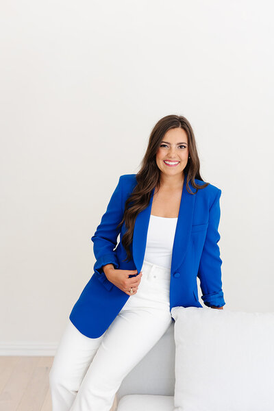 Headshot of Abby Manawes in a blue blazer and white pants