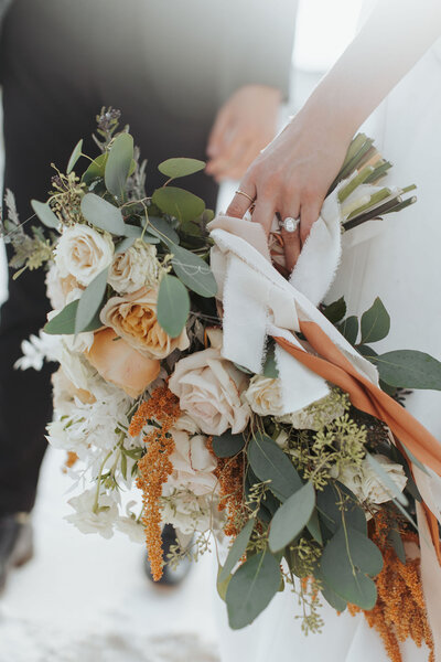 bridal bouquet with pale pink orange and white flowers