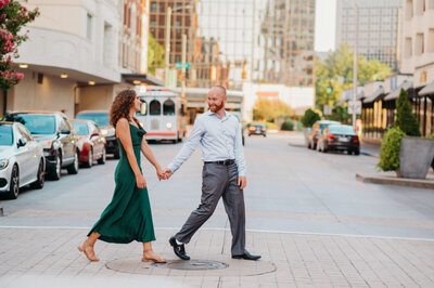 photo of man and woman walking across the street