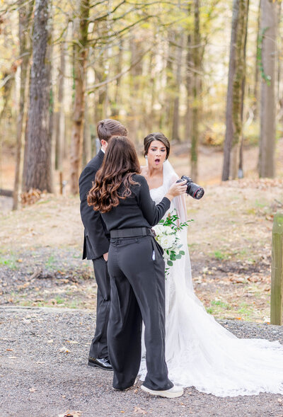Nashville wedding photographer Brooke Elliott showing the back of her camera to one of her bride's so she could see a portrait, and the bride's jaw drops to the floor