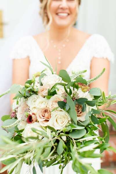 Bride holding her white and blush bouquet on her wedding day