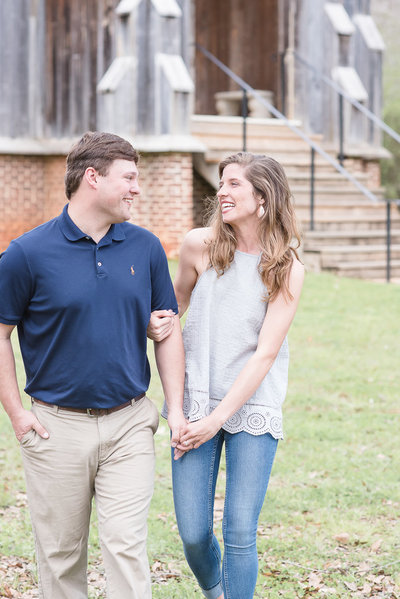 Couple laughing and walking at Old Cahawba engagement session