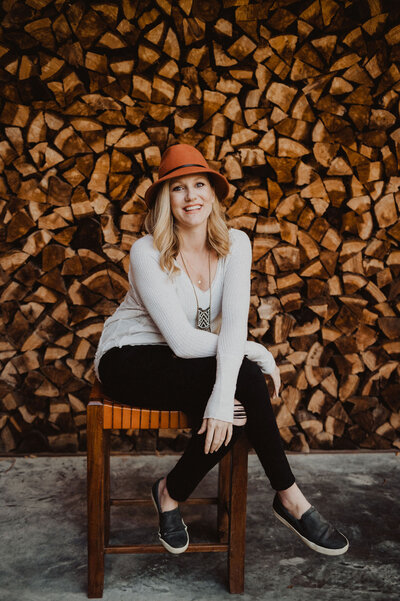 Woman smiling in front of logs
