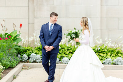 Bride and groom share a first look outside of St. Agnes in Saint Paul