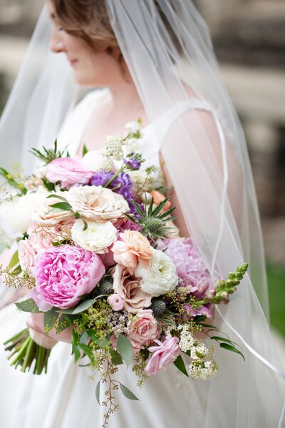 Bride with her flowers by Calgary wedding photographer Tara Whittaker