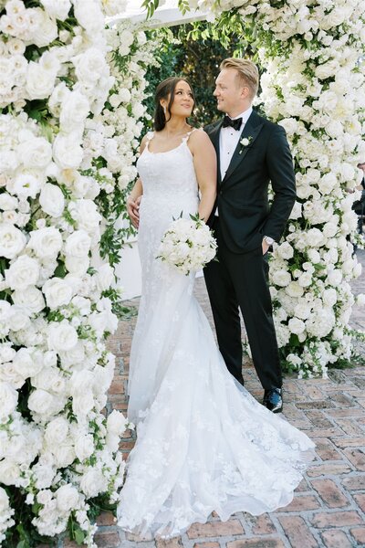 Bride and Groom lace wedding dress and lily of the valley bouquet