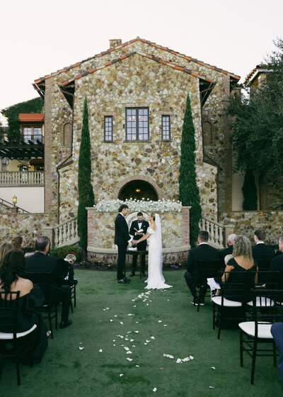 As the bride and groom made their grande entrance, family and friends shared their cheers and joy in preparation for the first dance between the two.