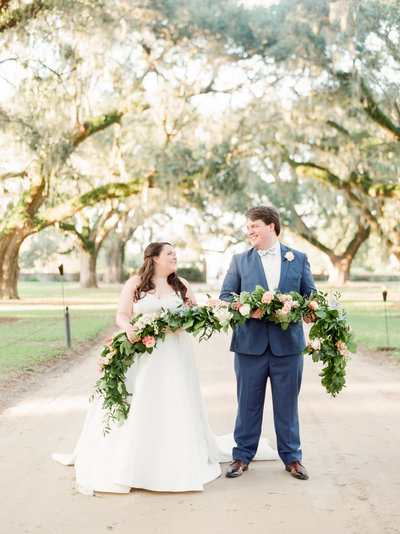 Bride and Groom with Greenery and Floral Garland and Boone Hall Plantation Avenue of Oaks Wedding
