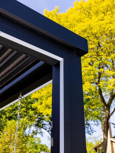 Black StruXure pergola frame with integrated TraX system with intregrated LED strip lights. 