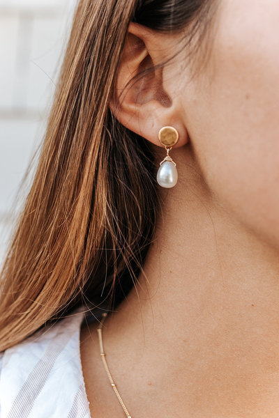 pearl earring on brunette