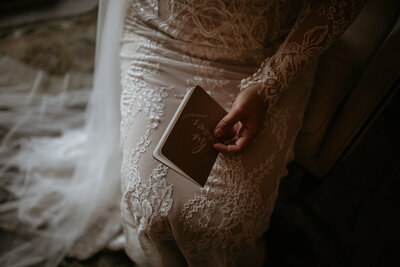 bride holding vows book