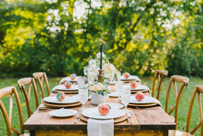 table setting with peaches & white plates