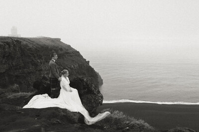 bride and groom walking infront of waterfall