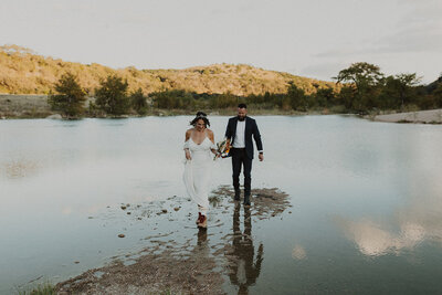 bride and groom eloping by the lake
