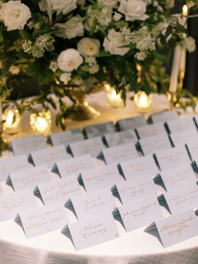 Tented escort cards with gold ink calligraphy for wedding at The Newbury Hotel in Boston