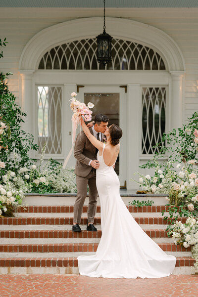 bride and groom embracing and kissing on their wedding day in Charleston, South Carolina.