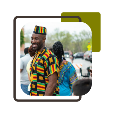 Wendell Scurlock wearing a kente shirt and hat