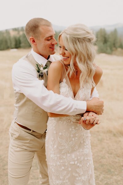 Couple Embracing in a Field - Logan & Chris | Schmidt Cattle Ranch Mead Washington Wedding