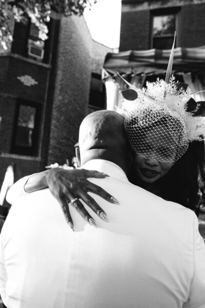 black and white image of groom hugging bride