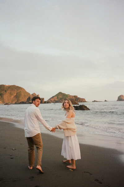 Couple holding hands secret beach oregon