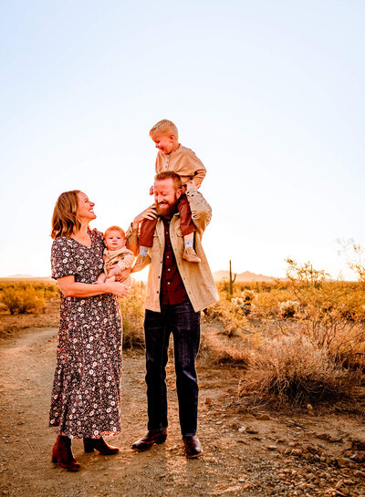 Parents with young kids laughing in Arizona during photography session