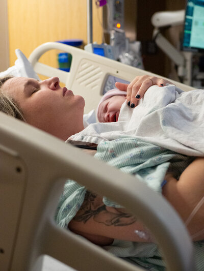 a mother holds her baby for the first time after giving birth.