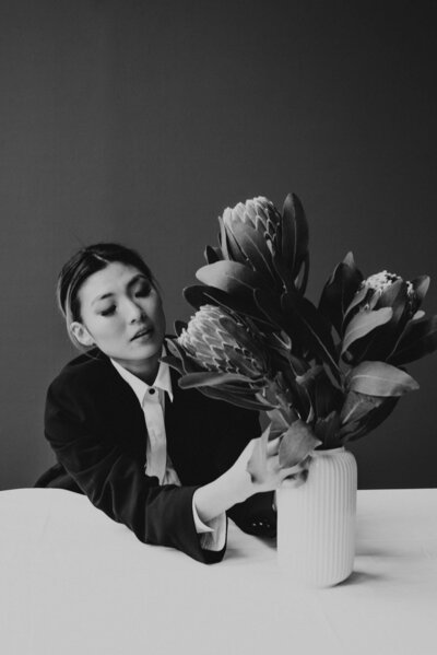 Woman adjusting flowers in a vase