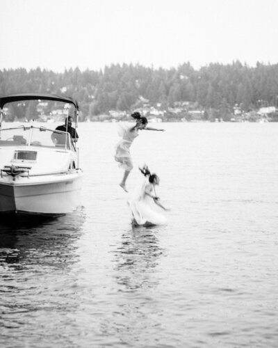 Bride and her maid of honor jump off a boat into Lake Washington