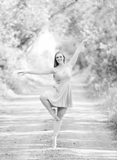 A beautiful ballerina carefully dances on a dirt road in Loleta.