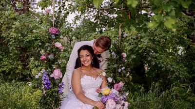 Bride and Groom on a flower swing