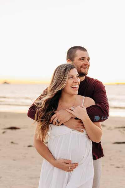 couple on the beach for a maternity photo session