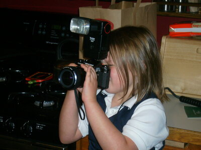 brianna kirk at seven years old taking a picture on a minolta 35mm camera