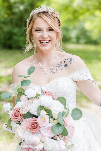 Bride laughing with bouquet