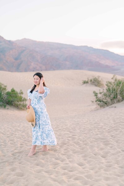 girl wearing blue & white dress on sand dunes