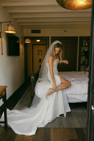 bride putting shoes on for elopement