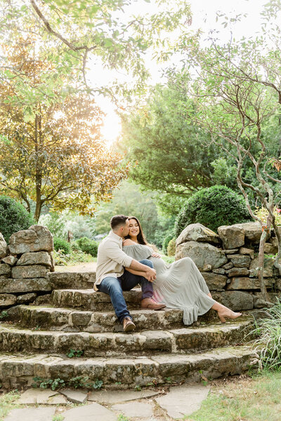 Expecting couple sitting in garden in Bernardsville, NJ