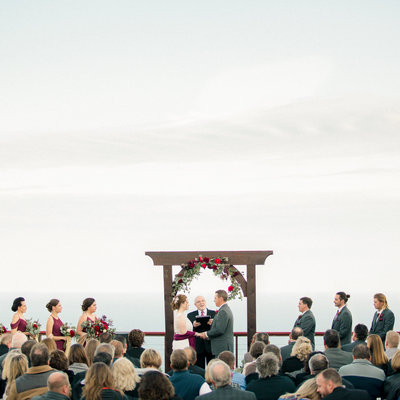 film photography of marriage ceremony on deck on top of a mountain overlooking lake supeiror