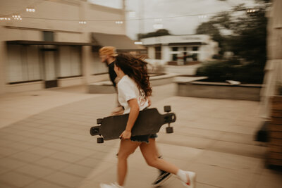 couple running with skateboards