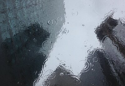 Raindrops on a window symbolizing emotional overwhelm and nervous system dysregulation