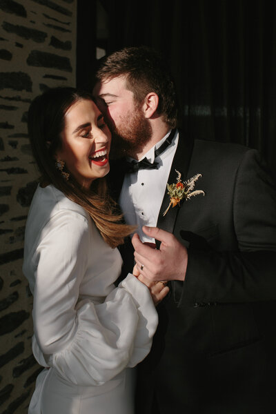The Lovers Elopement Co - bride and groom embrace and laugh