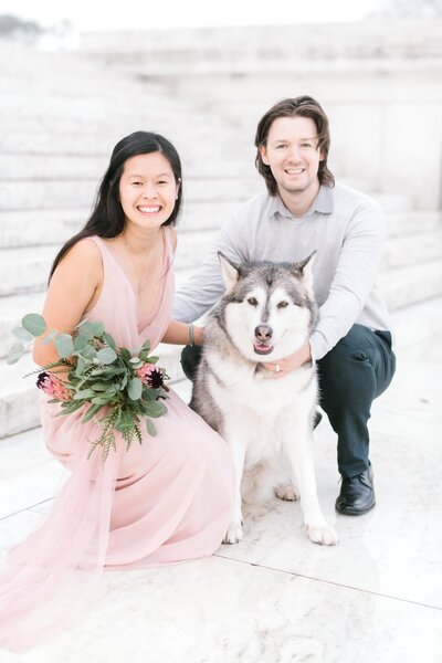 Couple sitting with their husky dog