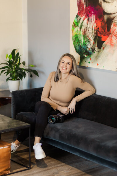 headshot of gatlinburg photographers sitting on a black couch casually 