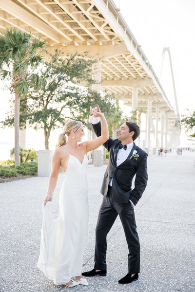 Wedding couple dancing at Ravenel bridge in Charleston, South Carolina