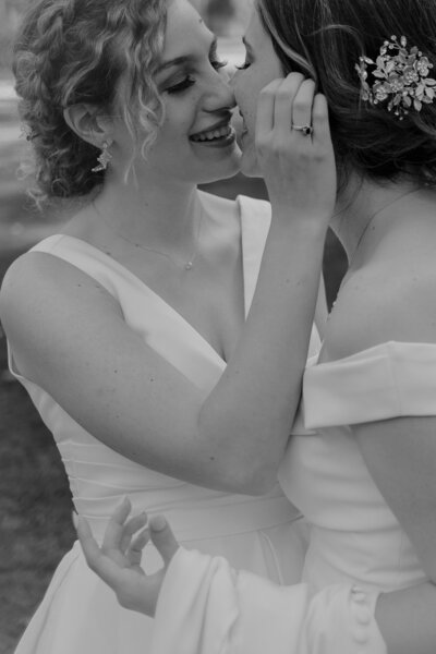 bride and bride kissing on their wedding day
