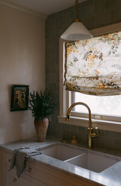 Interior Kitchen Sink Photo with Prints and Textures. Vintage art and vases. Subtle pop of colors.