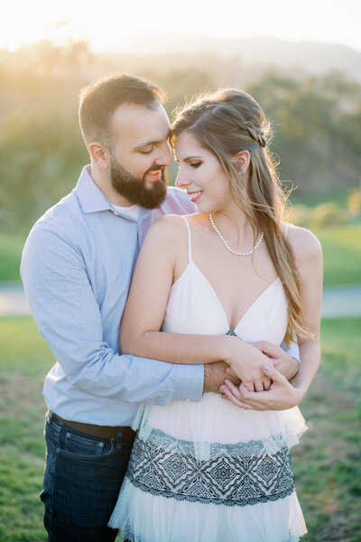 Engagement photo in a backlit golf field