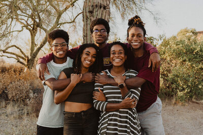 A group of siblings hugging and smiling.