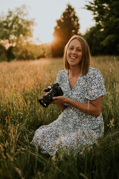 Jo in field at sunset with camera