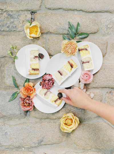 Slices of wedding cake decorated in fresh flowers